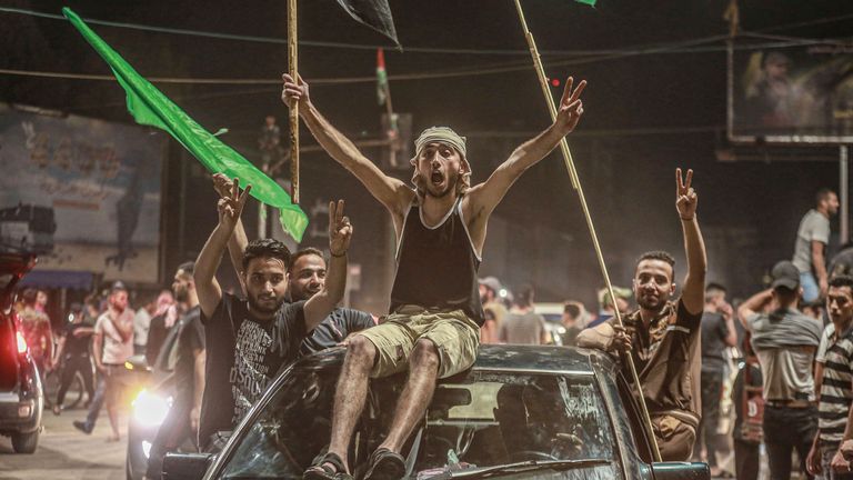 Palestinians take to the streets to celebrate a ceasefire agreement between the Israeli government and the Palestinian Islamist movement Hamas. Pic: AP