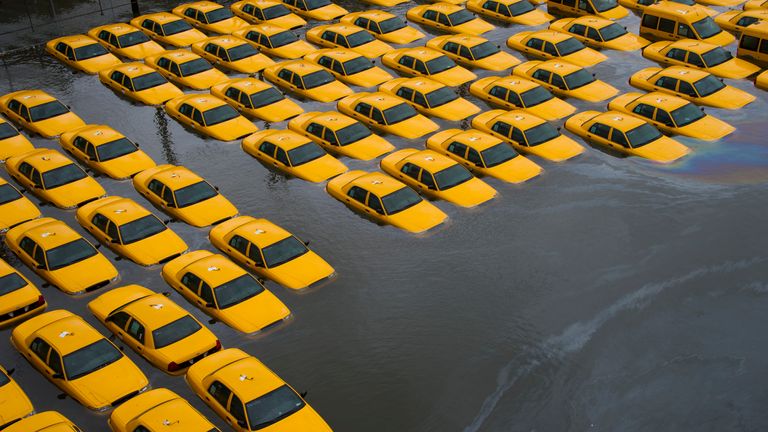 A parking lot full of yellow cabs is flooded as a result of superstorm Sandy on Tuesday, Oct. 30, 2012 in Hoboken, NJ. (AP Photo/Charles Sykes)