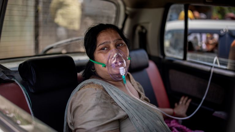 A woman breathes with the help of Oxygen in New Delhi