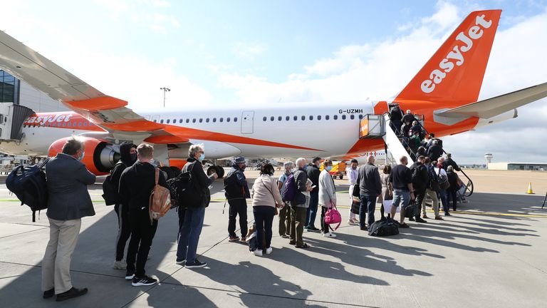 Passengers at Gatwick airport board a flight to Faro in Portugal