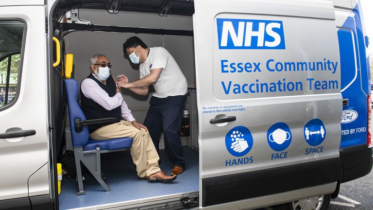 A man receives his jab inside a bespoke mobile vaccination van aimed at targeting vulnerable communities