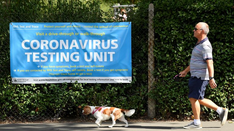 Outbreak of the coronavirus disease (COVID-19) in London
A man walks his dog past a poster promoting the coronavirus disease (COVID-19) testing at local mobile test centres, in Hounslow, London, Britain August 4, 2020. REUTERS/Toby Melville