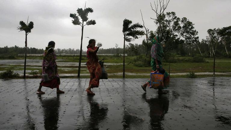 People move to a safer place as the cyclone approaches the eastern state of West Bengal