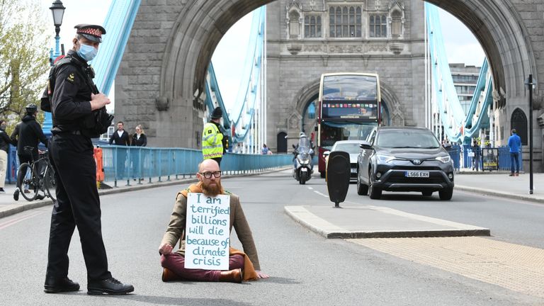 Extinction Rebellion (XR) handout photo of Morgan Trowland, 38, blocking traffic on Tower Bridge in London