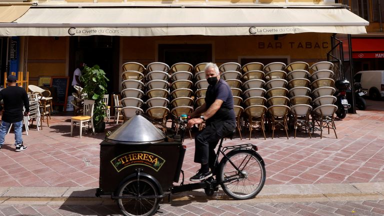 Chairs are stacked on the terrace of a restaurant during preparations for the reopening of restaurants in Nice as part of an easing of the country&#39;s lockdown restrictions amid the coronavirus disease (COVID-19) outbreak in France, May 18, 2021. 