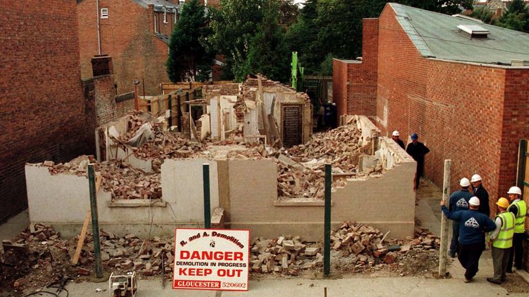 Workmen watch as 25 Cromwell Street Gloucester, the former home of serial killers Fred and Rosemary West, is demolished October 11.
