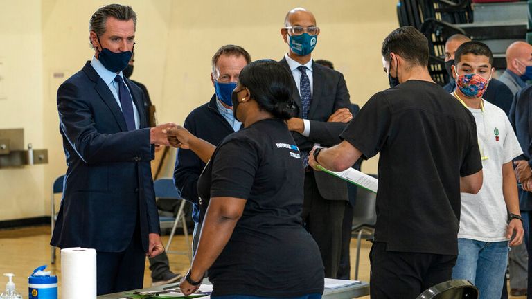 Governor Gavin Newsom (left) at a school in Los Angeles. Pic: AP