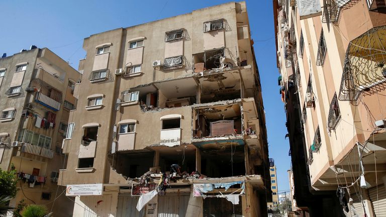 A Palestinian man inspects a damaged apartment in the aftermath of Israeli air strikes, amid a flare-up of Israeli-Palestinian violence, in Gaza City May 15, 2021. REUTERS/Mohammed Salem