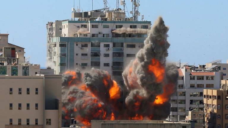 An explosion is seen near a tower housing AP, Al Jazeera offices (C) during Israeli missile strikes in Gaza city, May 15, 2021. REUTERS/Ashraf Abu Amrah NO RESALES. NO ARCHIVES.