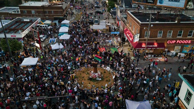 People gather at George Floyd Square, a year after Mr Floyd&#39;s death