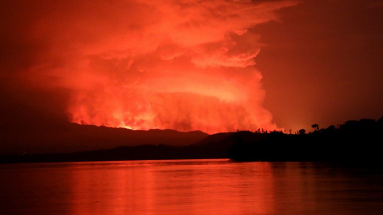 Smoke and flames are seen at the Nyiragongo volcanic eruption from the Tchegera Island on Lake Kivu, near Goma, in the Democratic Republic of Congo May 22, 2021. Picture taken May 22, 2021. REUTERS/Alex Miles 