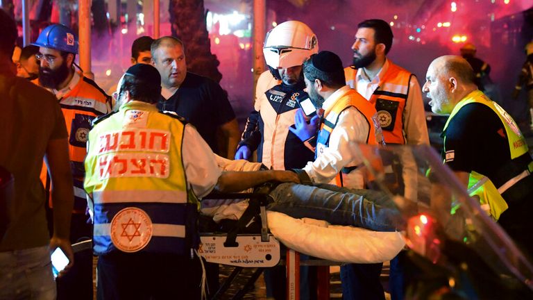 Israeli medics treat a man injured in the airstrikes. Pic: AP