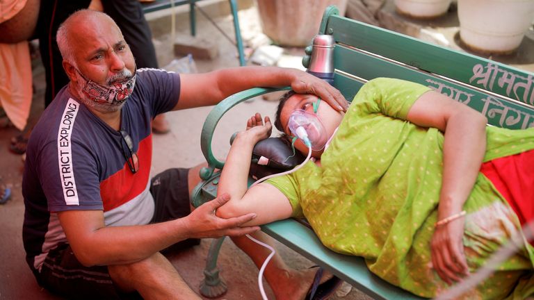 A woman receives oxygen support for free outside a Sikh temple in Ghaziabad, Uttar Pradesh, India