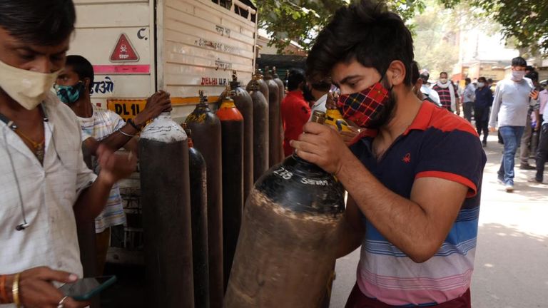 People queue to get fresh supplies of oxygen in India