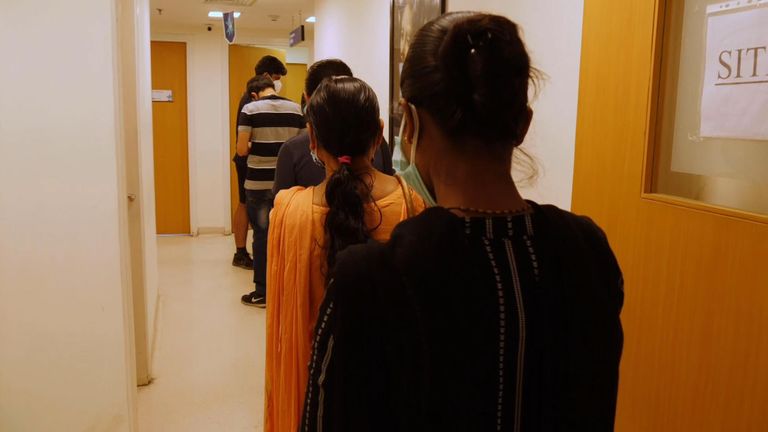 People wait to be given their vaccine against COVID in India