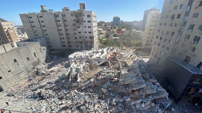 A tower housing the AP and Al Jazeera offices collapses after an air strike