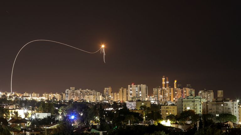 A streak of light is seen as Israel&#39;s Iron Dome anti-missile system intercepts rockets launched from the Gaza Strip