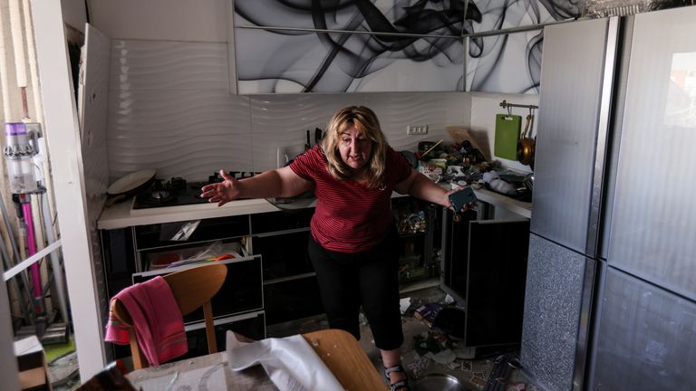 A woman reacts at her kitchen in an apartment of a damaged building following a rocket attack from Gaza, in Ashdod, Israel May 17, 2021. REUTERS/Ronen Zvulun