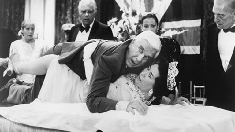 Jeannette Charles as the Queen with Leslie Nielsen in Naked Gun: From The Files Of Police Squad in 1988. Pic: Paramount Pictures/ IMDB Pro