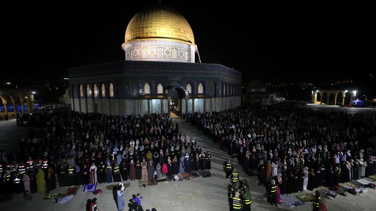 Palestinians pray in front of the Dome of the Rock in Jerusalem&#39;s Old City on Saturday night