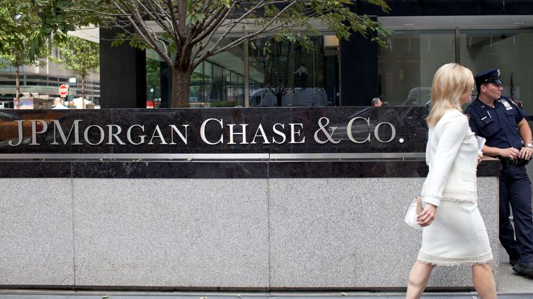  A woman walks past JPMorgan Chase & Co&#39;s international headquarters on Park Avenue in New York July 13, 2012.