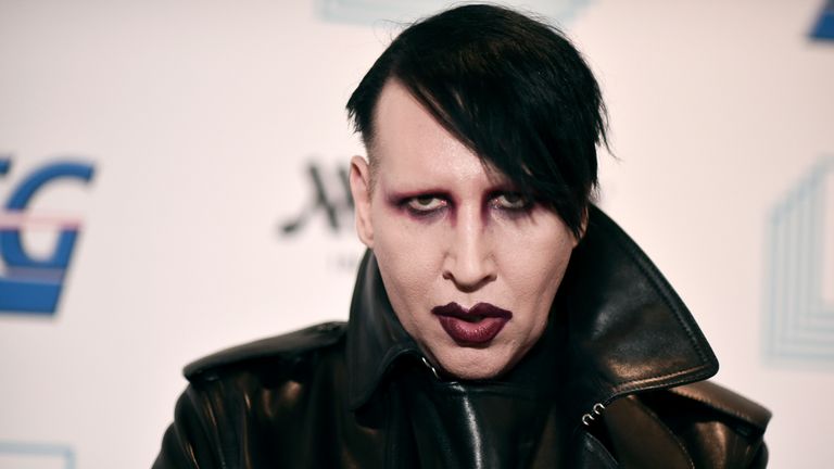 FILE - In this Dec. 10, 2019, file photo, Marilyn Manson attends the 9th annual "Home for the Holidays" benefit concert in Los Angeles. Detectives are investigating Manson for allegations of domestic violence that reportedly occurred about a decade ago in West Hollywood, authorities said. The domestic violence is believed to have occurred between 2009 and 2011, when Manson lived in the city of West Hollywood. (Photo by Richard Shotwell/Invision/AP, File)