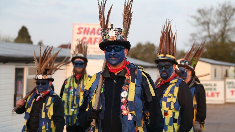 Members of the Hook Eagle Morris Men perform outside the Shack Cafe near to Hook in Hampshire as they see in the May Day dawn. It is the first time they have been able to perform together since January 2020 and is the first time they have performed in their new Blue face paint. Picture date: Saturday May 1, 2021.