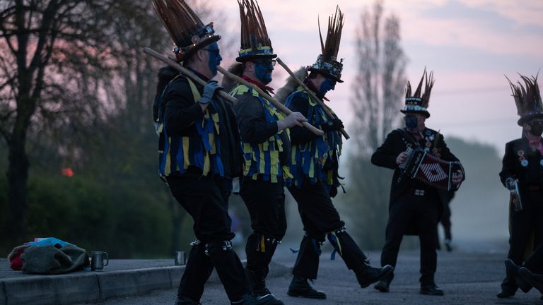 Members of the Hook Eagle Morris Men perform outside the Shack Cafe near to Hook in Hampshire as they see in the May Day dawn. It is the first time they have been able to perform together since January 2020 and is the first time they have performed in their new Blue face paint. Picture date: Saturday May 1, 2021.