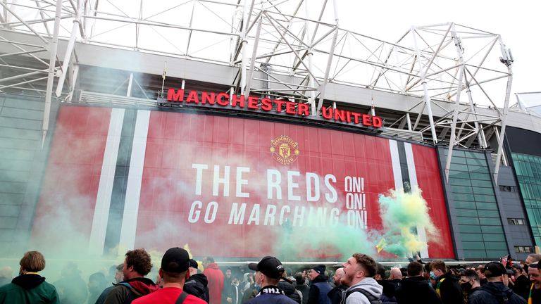 Fans set off flares during a protest against the Glazer family