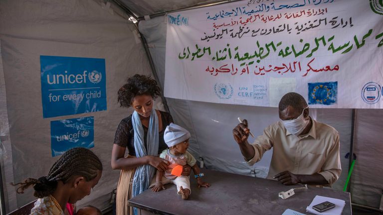 Tigray women who fled the conflict in Ethiopia...s Tigray region, take shelter inside a UNICEF tent, as Filippo Grandi, U.N. High Commissioner for Refugees, visits Umm Rakouba refugee camp in Qadarif, eastern Sudan, Saturday, Nov. 28, 2020. (AP Photo/Nariman El-Mofty)