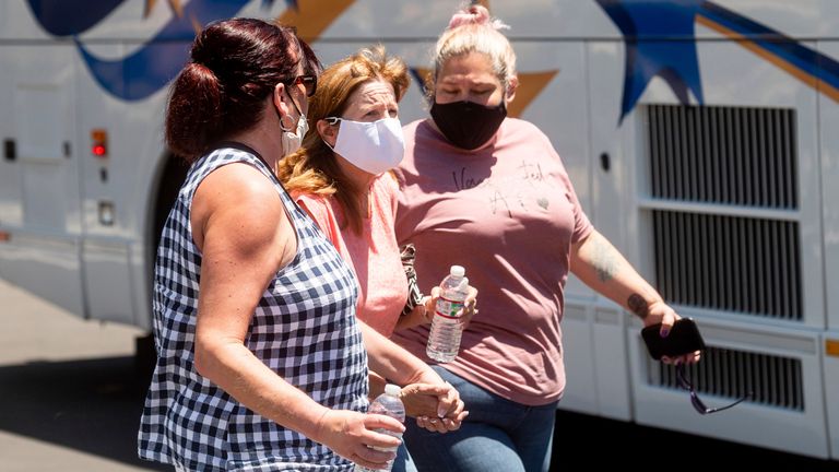 A woman is led away from the scene of the shooting Pic: AP