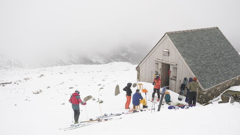 Skiers rest during heavy snowfall at the Lake District Ski Club on Raise, next to Helvellyn in the Lake District National Park, after an unseasonal May snowfall allowed the reopening of the slopes. Picture date: Thursday May 6, 2021.