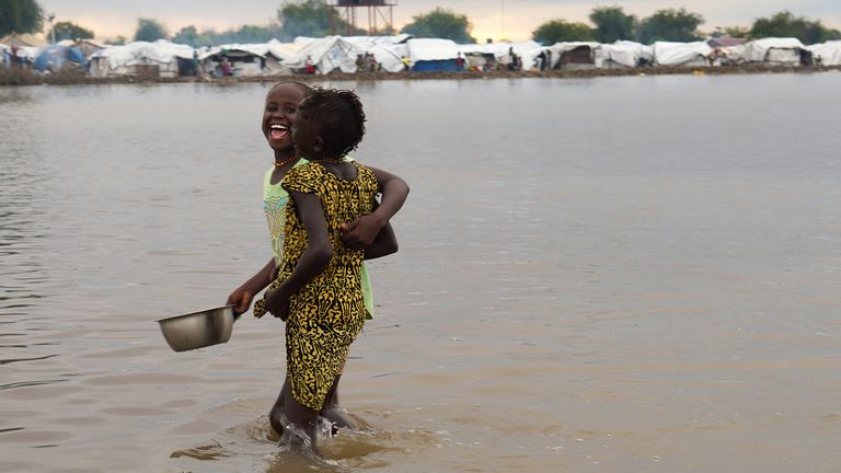 Displaced children wade through floodwaters after the River Nile broke the dykes in Pibor last year