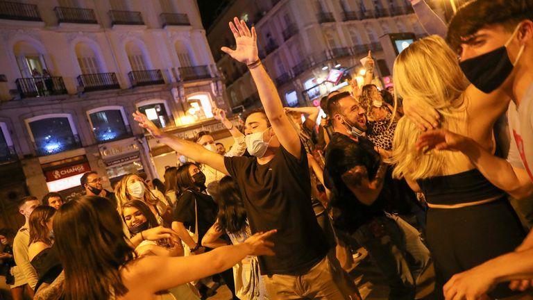 People celebrate as the state of emergency decreed by the Spanish Government to prevent the spread of the coronavirus disease (COVID-19) gets lifted at Puerta del Sol square in Madrid, Spain, May 9, 2021. REUTERS/Susana Vera