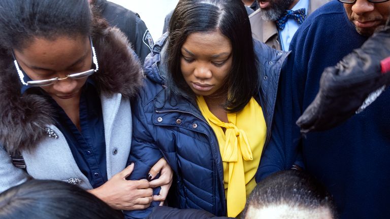  Tova Noel, centre in yellow blouse, a federal jail guard Pic: AP