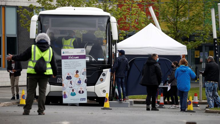 People line up outside a mobile vaccination centre, amid the outbreak of the coronavirus disease (COVID-19), in Bolton, Britain, May 13, 2021. REUTERS/Phil Noble