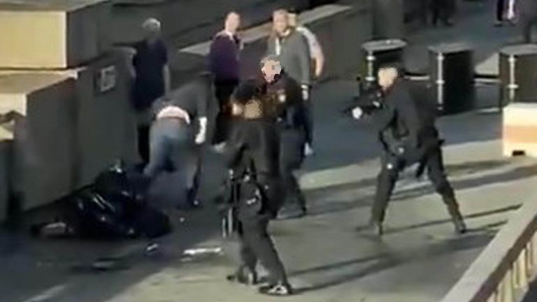 Police and bystanders surround Usman Khan on London Bridge