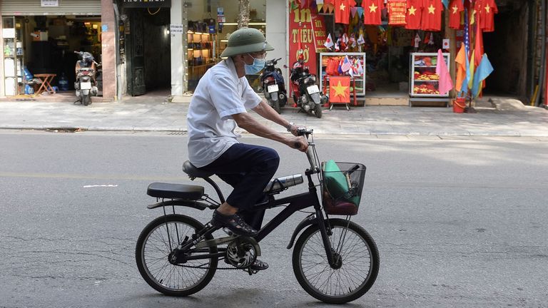A man rides a bike on an empty street amid the coronavirus (COVID-19) pandemic, in Hanoi, Vietnam, May 31. REUTERS/Thanh Hue
