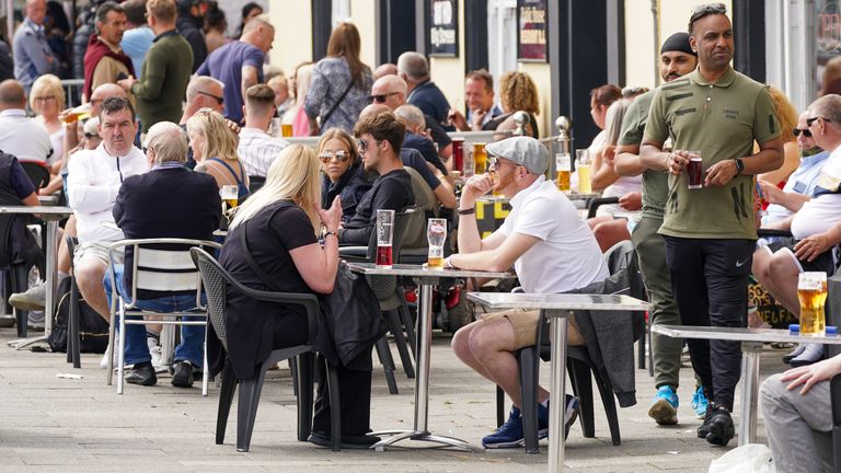 People enjoy a drink at a pub along the seafront in Southend