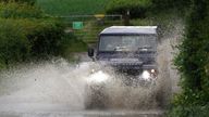A car drives through a flooded road near Chesham, Buckinghamshire as rain and thunderstorms are set to sweep the South East in the coming days. Picture date: Friday June 18, 2021.