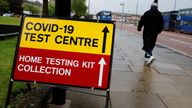 A man walks past a sign directing people to a testing station, amid the outbreak of the coronavirus disease (COVID-19) in Bolton, Britain, May 17, 2021