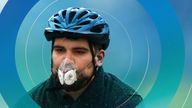 A cyclist wears a mask with an air filter as he cycles through Hyde Park in London April 3, 2014. A dust cloud from the Sahara has covered south east England, raising pollution levels to the highest level in London, preventing people taking exercise outdoors, including the Prime Minister, David Cameron, who said he had skipped his morning jog. 