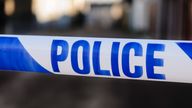 Police tape at the cordon across a crime scene