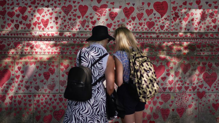 People stood next to the National Covid Memorial Wall on the Embankment in London, following the further easing of lockdown restrictions in England. Picture date: Saturday June 12, 2021.