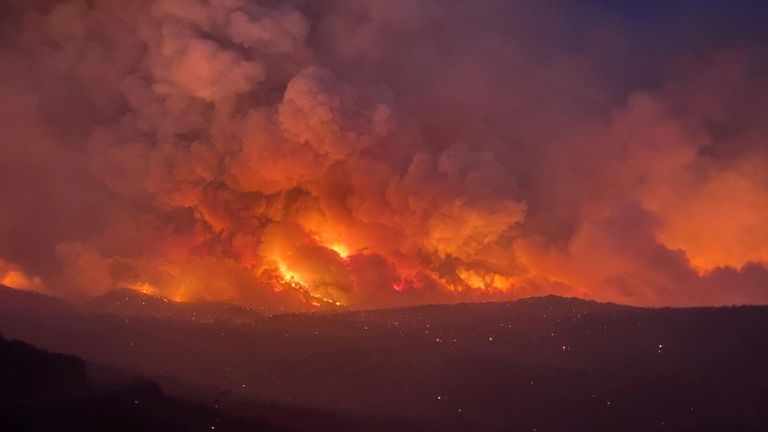 Smoke plumes rise from a blaze as a wildfire rages on in Arizona,