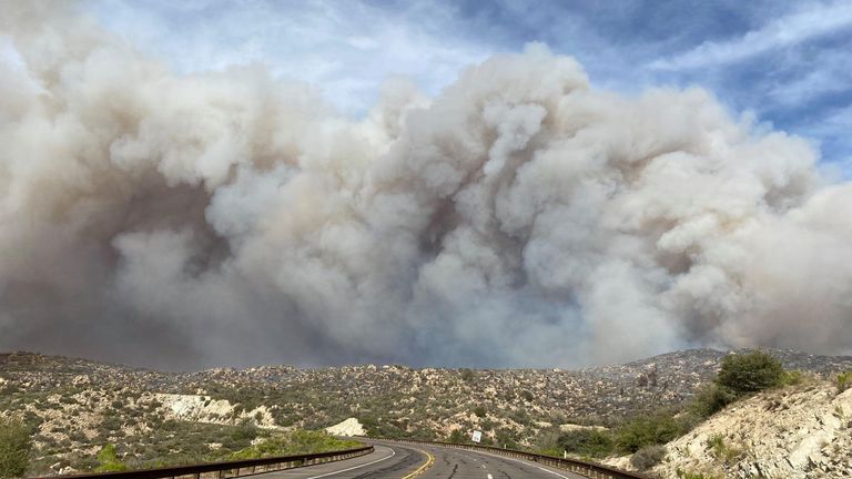 Smoke plumes rise from a blaze as a wildfire rages on in Arizona