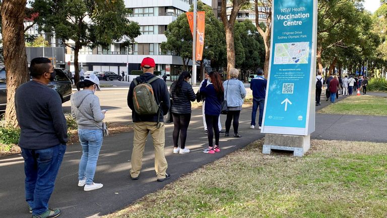 People wait in line outside a vaccination centre at Sydney Olympic Park in Sydney, Australia. Pic: AP