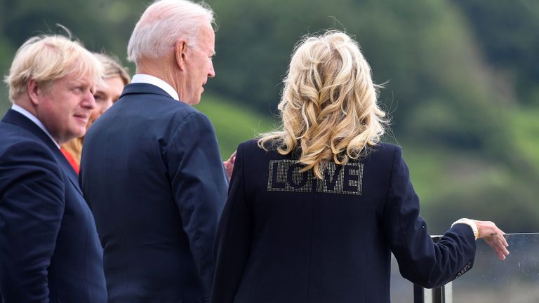 Jill Biden wearing a jacket with the word "Love" stands next to U.S. President Joe Biden, Britain&#39;s Prime Minister Boris Johnson and his wife Carrie Johnson