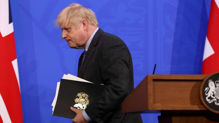 Boris Johnson leaves the media briefing where he announced a delay in the easing of lockdown in England