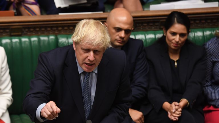 Boris Johnson is pictured alongside Mr Javid in the Commons in 2019